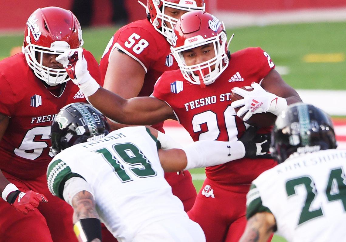 Fresno State’s Ronnie Rivers, right, cuts back against Hawai’i’’s Kamali’l Akina, left, Saturday, Oct. 24, 2020 in Fresno. The first quarter ended tied 7-7.