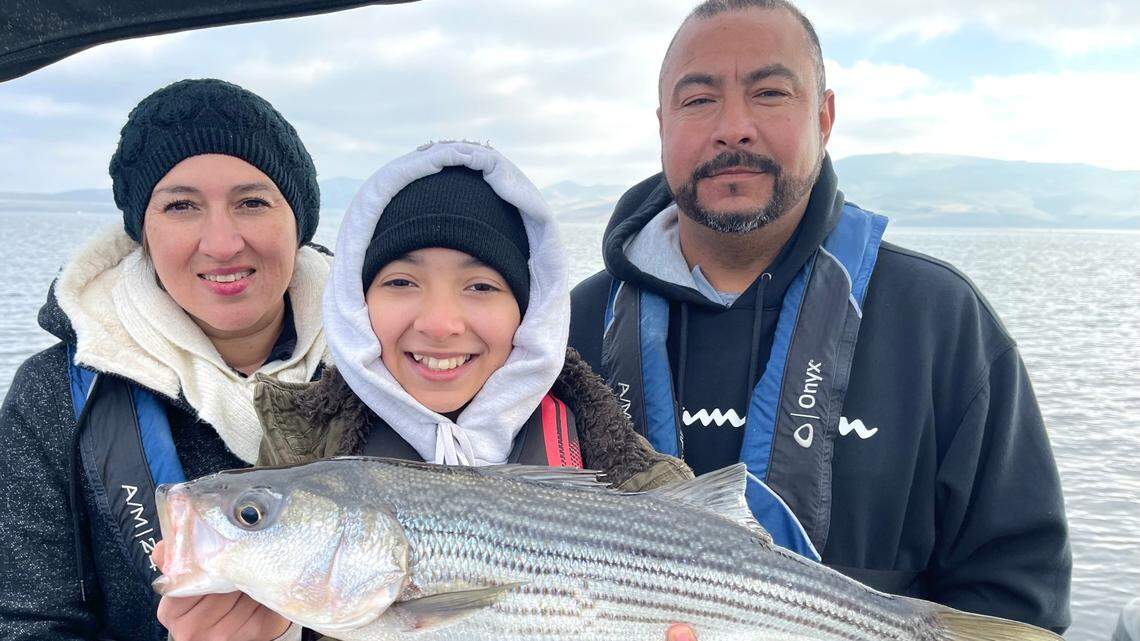 The Anayas of Parlier caught 14 stripers up to 25 inches on a Sunday, Dec. 5 trip to San Luis Reservoir with guide Roger George. Blanca Anaya, left, and Ociel Anaya, right, pose with daughter Andrea, 14.
