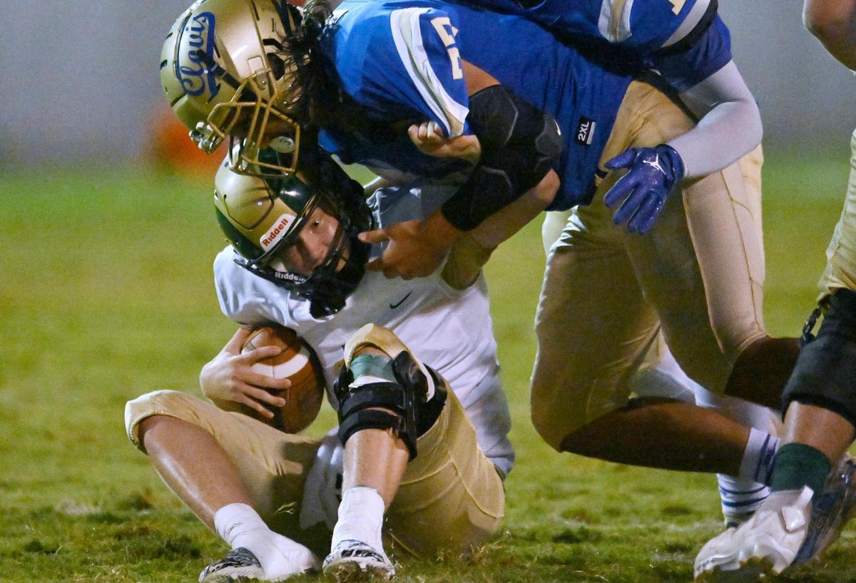 Clovis High’s Logan Cordero, top, sacks Garces quarterback Gunter Golla, bottom, Thursday, Aug. 17, 2023 in Clovis.