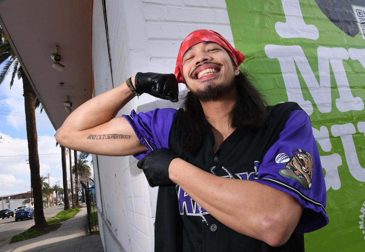 Eddie Wutangsy, displaying a tattoo of his motto for life, has opened My Guy Market, a ghost kitchen along Belmont Avenue just north of downtown. It’s an online app-driven bodega for customers, offering New York City-inspired food and more.