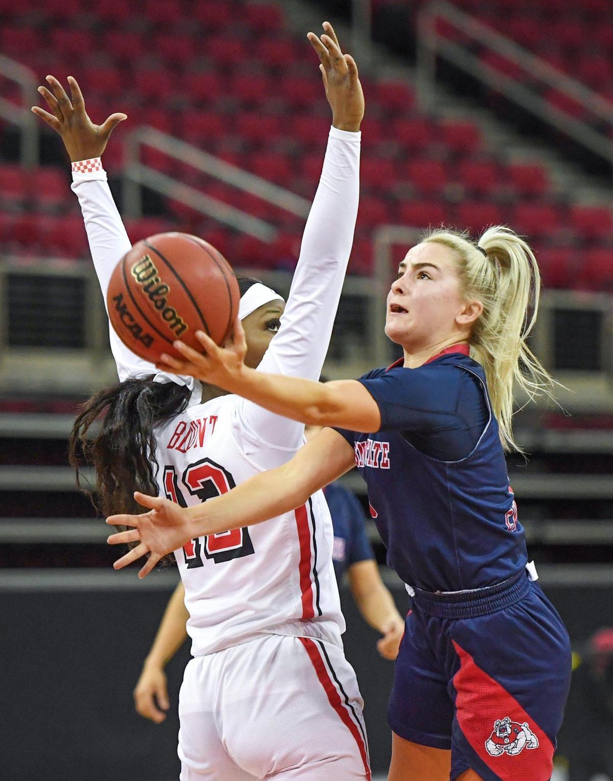 Fresno State guard Hanna Cavinder, right, gets up a shot around UNLV’s Anna Blount during the Bulldogs’ 75-74 loss to the Rebels at the Save Mart Center on Saturday, Feb. 27, 2021.