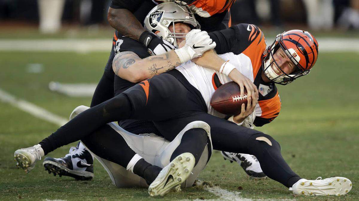 Raiders defensive end Maxx Crosby sacks former Cincinnati Bengals quarterback Ryan Finley in a game in 2019.