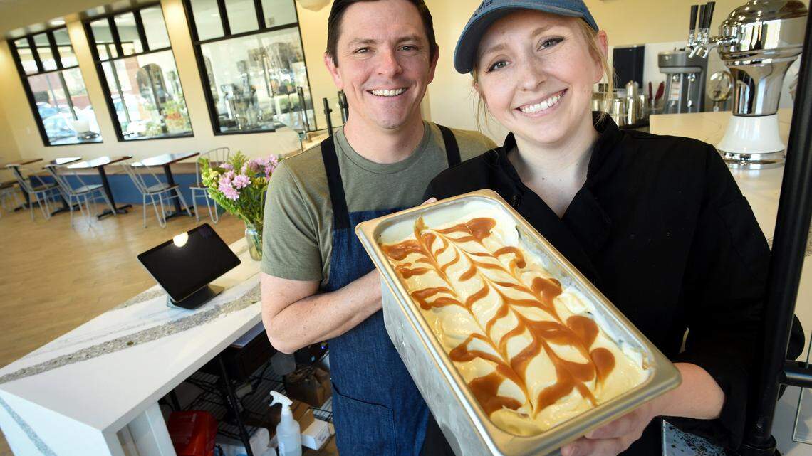 Ampersand ice cream shop owners Jeff and Amelia Bennett hold a fresh batch of their whiskey-caramel swirl ice cream in this file photo from 2019. The couple is planning to open a third ice cream shop, this time in northeast Fresno. 