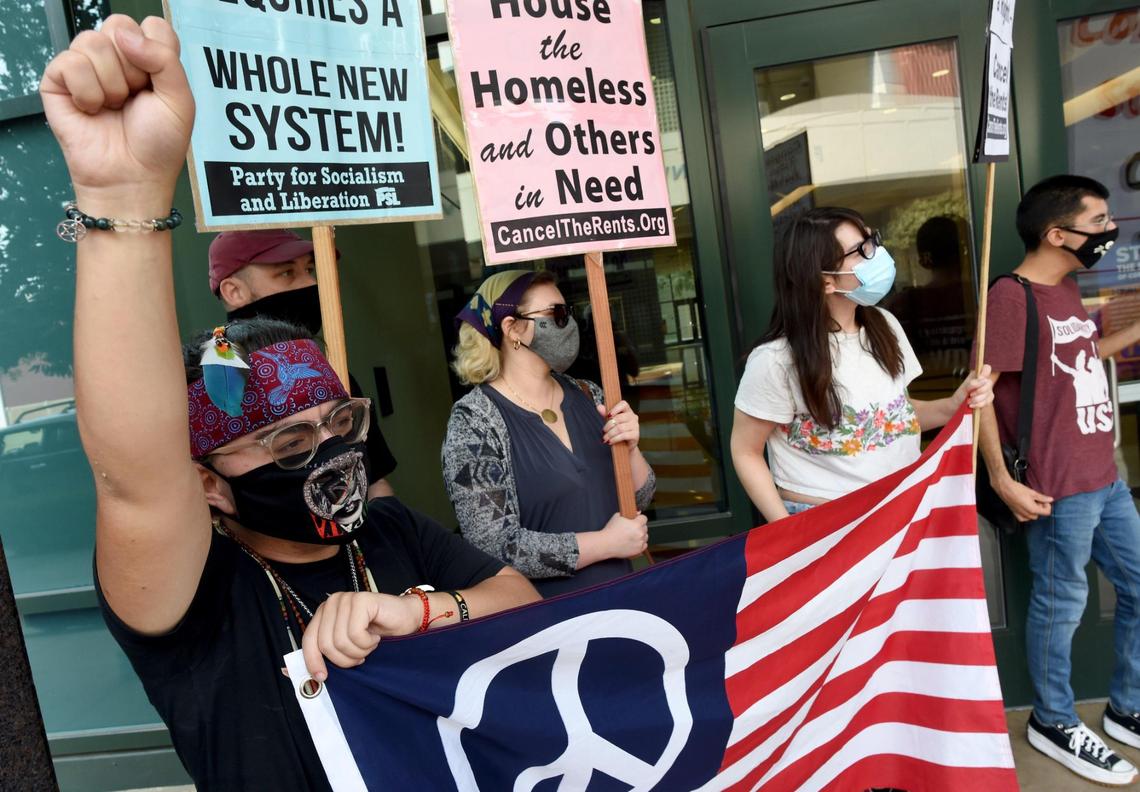 Ronnie Kassis of Fresno, left, joins with other housing rights activists during the Stop All Evictions! protest Saturday Sept. 25, 2021, in front of Rep. Jim Costa’s office.