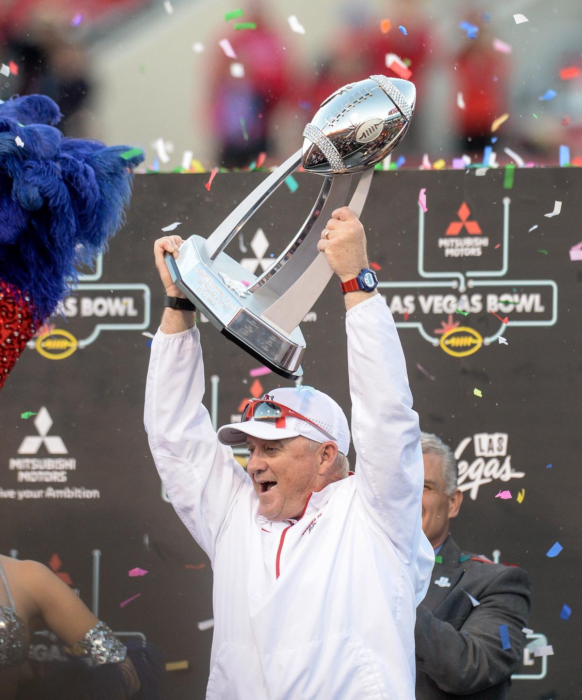Fresno State head coach Jeff Tedford raises the Mitsubishi Las Vegas Bowl championship trophy during a post-game presentation following Fresno State’s victory over Arizona State in the Las Vegas Bowl at Sam Boyd Stadium in Las Vegas on Saturday, Dec. 15, 2018.