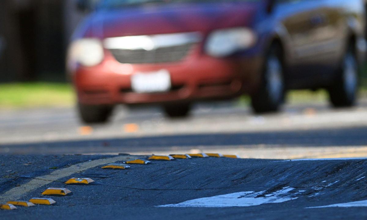 Reflectors in the road show the undulating nature of speed bumps along Chestnut Ave. between Gettysburg and Ashlan avenues Tuesday, Jan. 9, 2024 in Fresno.
