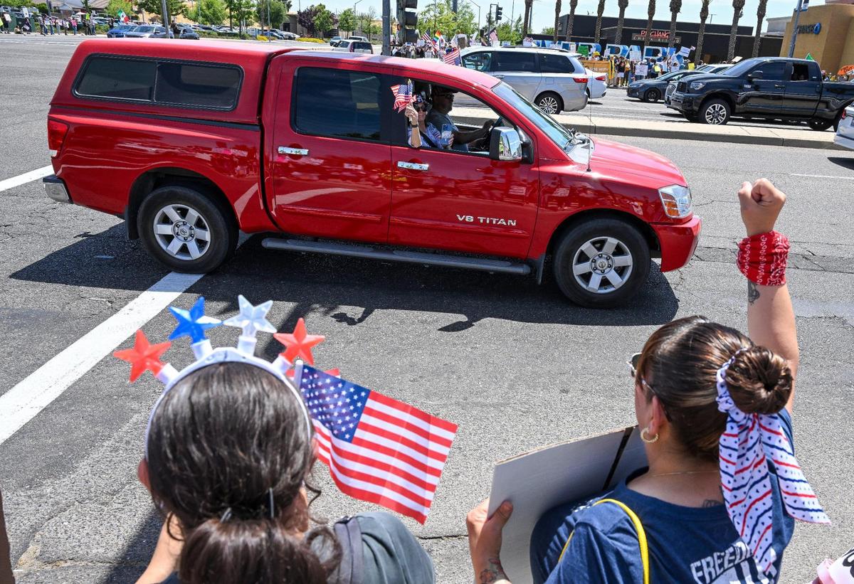 Protestors cheer on supporters driving by on Blackstone Avenue at Nees near River Park shopping center during a no kings protest against President Donald Trump’s policies in Fresno on Saturday, June 14, 2025.