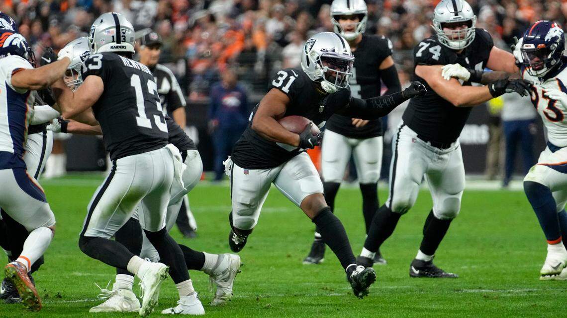 Las Vegas Raiders running back Peyton Barber rushes during the second half of an NFL game against the Denver Broncos, Sunday, Dec. 26, 2021, in Las Vegas.