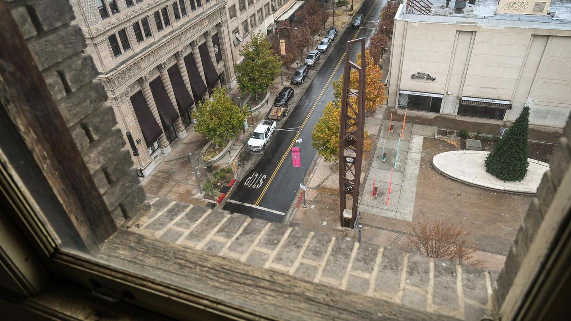 The historic Fulton Clock Tower in downtown Fresno’s Mariposa Plaza comes into view out the window of an eighth floor window of the historic Helm Building on Thursday, Dec. 1, 2022. Sevak Khatchadourian, who has successfully renovated the Pacific Southwest Building, is hoping to develop the Helm Building with new micro apartments.