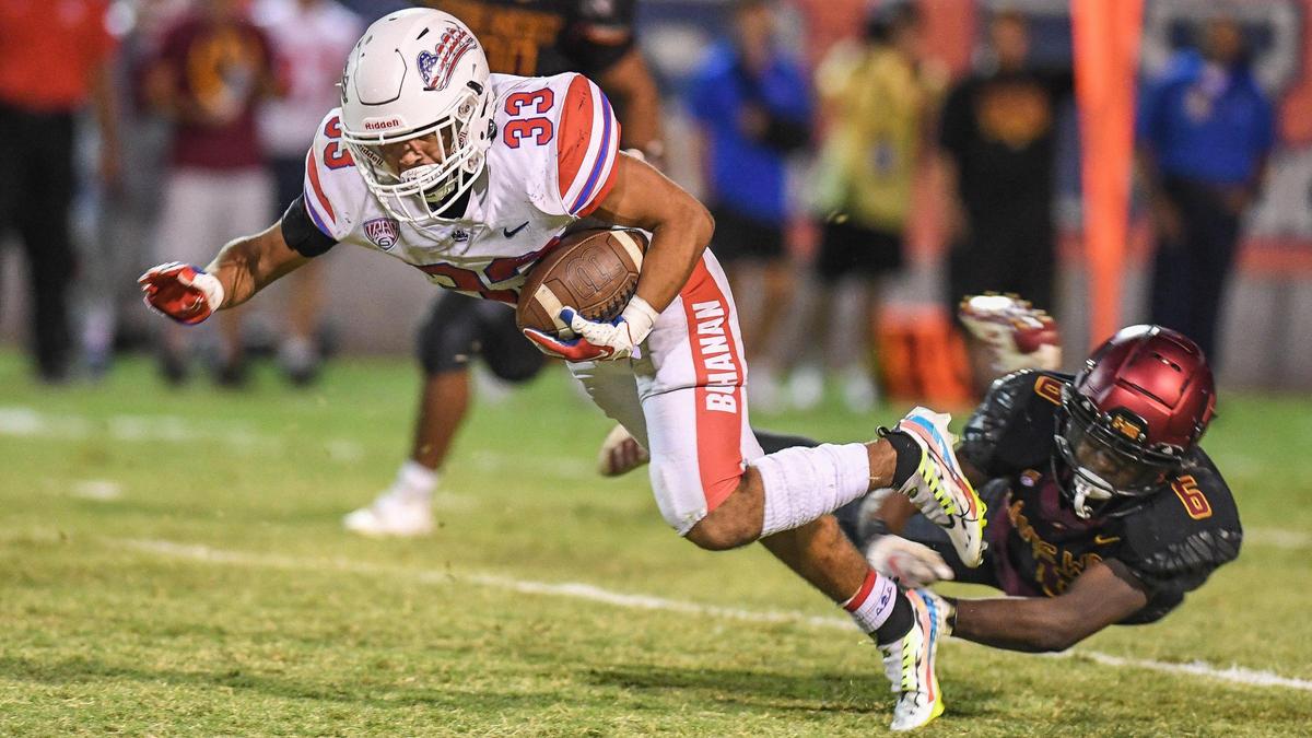 Buchanan’s Michael Runnels gets tripped up by Clovis West’s Tyler Patrick while on a run up the middle during their game at Lamonica Stadium in Clovis on Friday, Sept. 30, 2022.