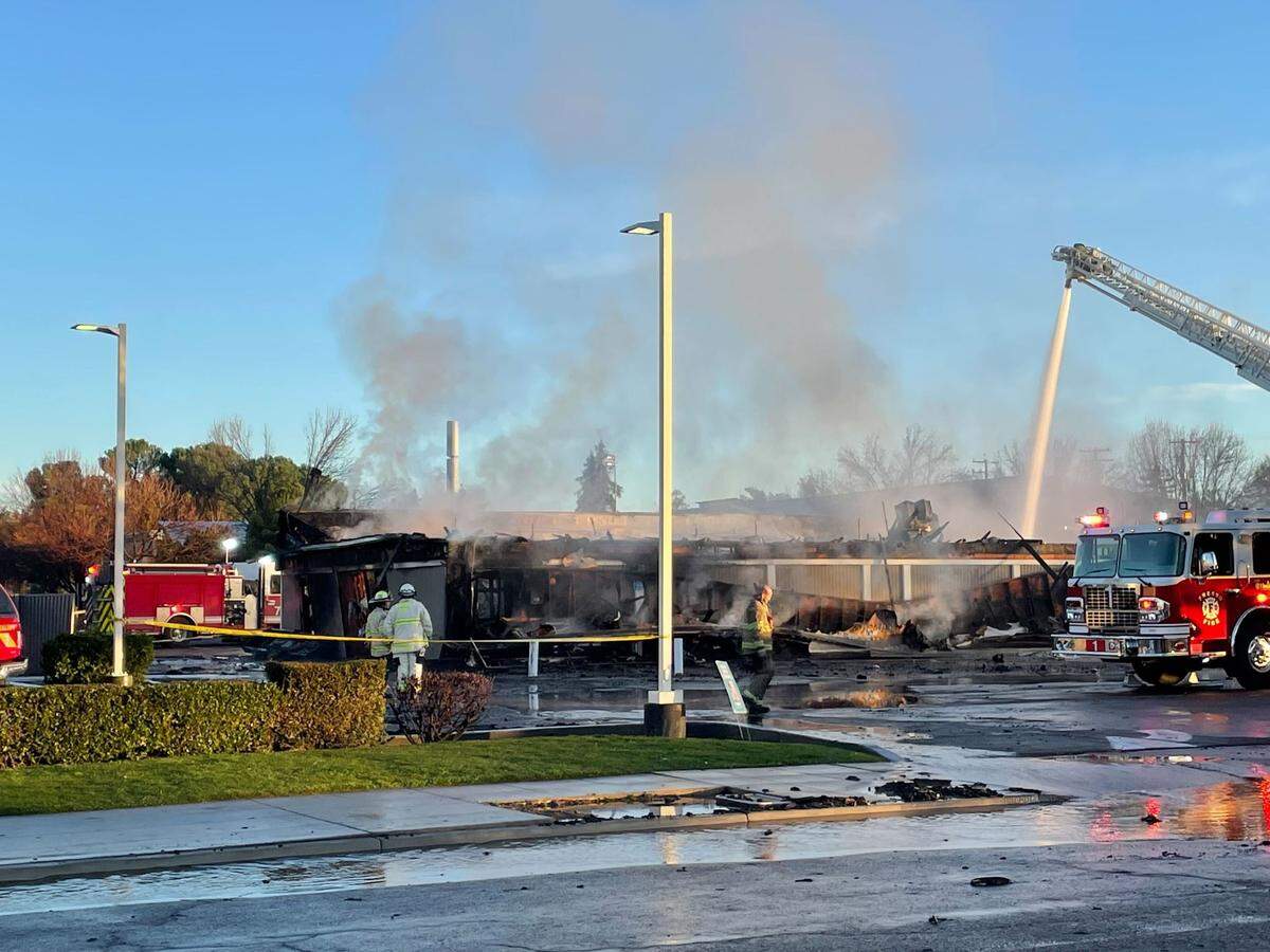 A strip mall at Kings Canyon Road and Phillip Avenue caught fire Friday, Jan. 6, 2023, in southeast Fresno, California. The building was home to Irish O’Sullivan’s Sunnyside Lounge Restaurant and Pub and Sunnyside Deli.