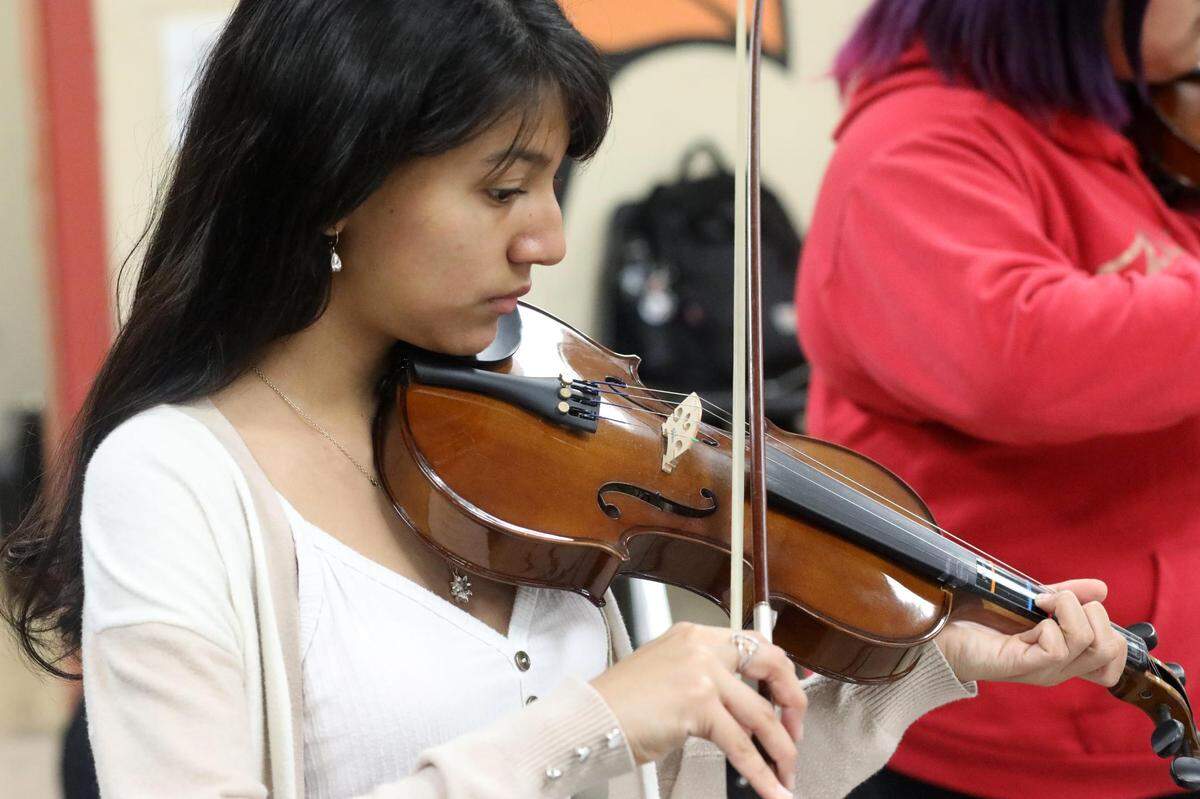 Orosi High School Mariachi Cardenal violin player during the mariachi class on Wednesday, March 15, 2023.