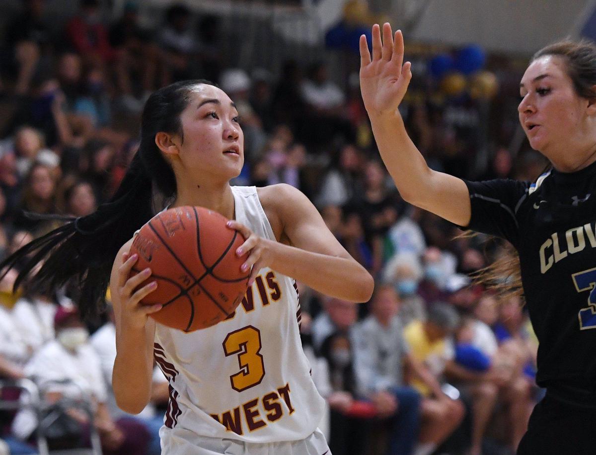 Clovis West’s Nikki Tom, left, goes up against Clovis High’s Carlie Vanek, right, in the Central Section Open Division girls basketball championship Thursday, June 10, 2021 in Fresno.