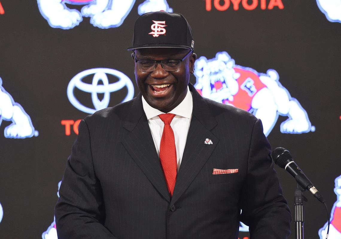 Terry Tumey laughs as he poses with a Fresno State cap presented by university president Joseph Castro after Tumey was named athletics director during a press conference Monday morning, June 25, 2018 in Fresno.