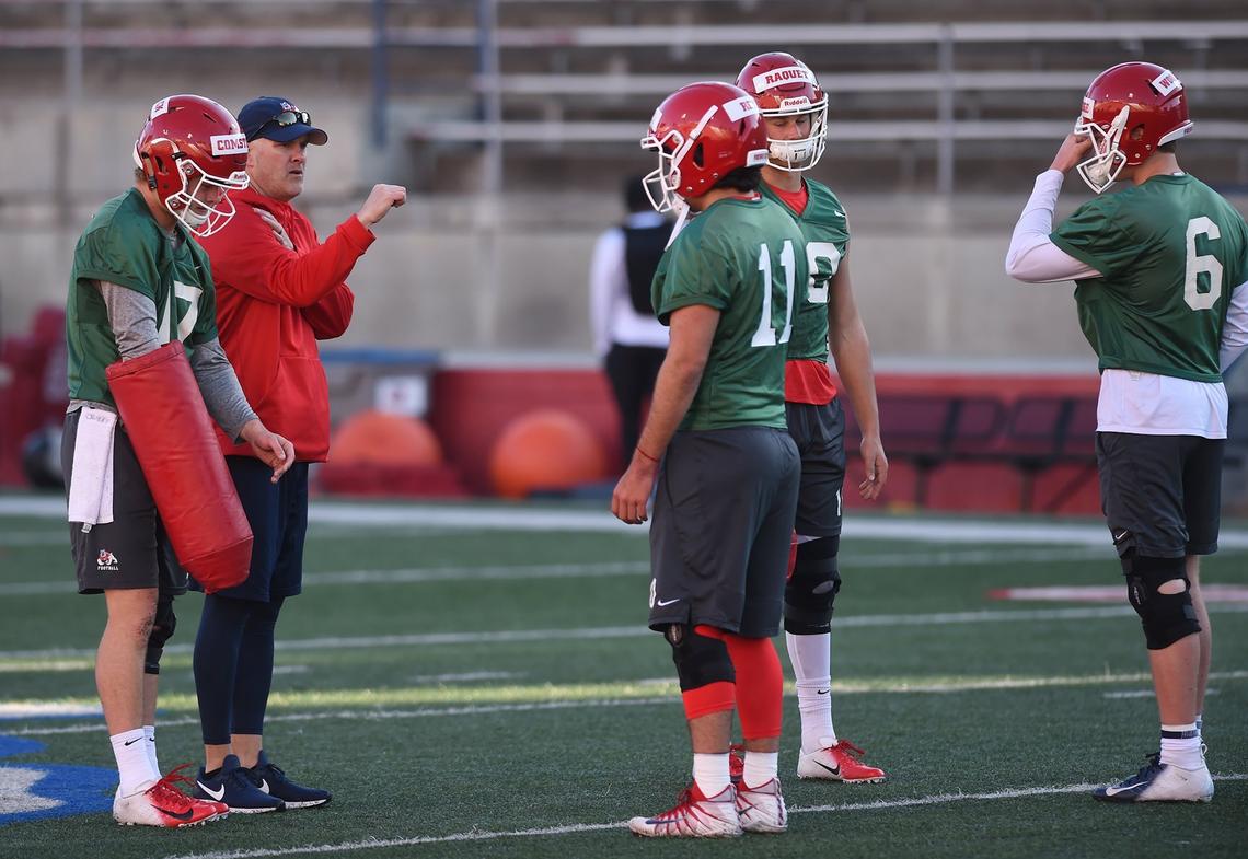 Fresno State quarterback coach Danny Langsdorf, second from left, works with the quarterbacks during spring practice in March. The Bulldogs are down to three scholarhip QBs after sophomore Hunter Raquet, back, left the program in the first week of spring practice. The remaining QBs are redshirt freshman Steven Comstock, left; senior Jorge Reyna, center; and redshirt freshman Ben Wooldridge, right.