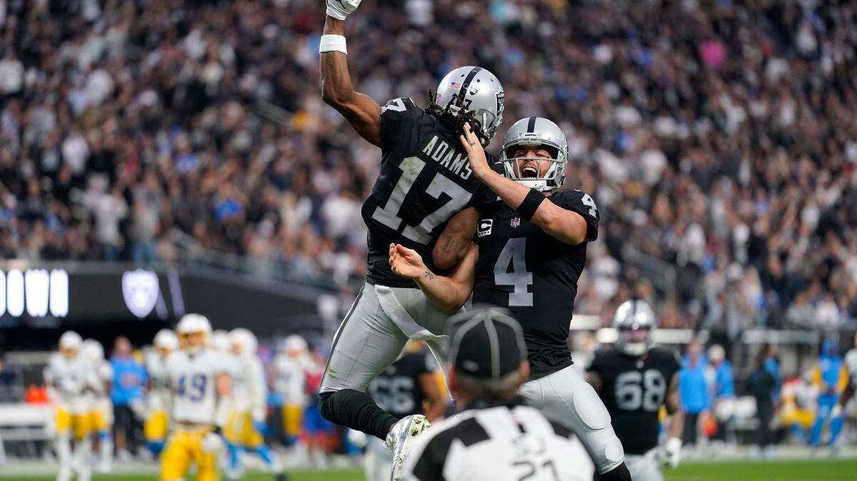 Las Vegas Raiders quarterback Derek Carr and wide receiver Davante Adams (celebrate their touchdown during the second half of an NFL game against the Los Angeles Chargers, Sunday, Dec. 4, 2022, in Las Vegas.
