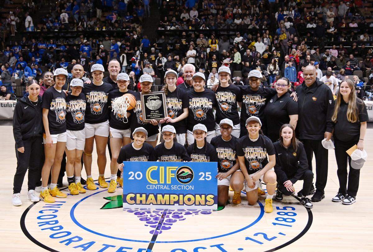 Clovis West’s girls basketball team poses for a photo after beating Clovis High for the CIF Division I Girls Basketball Championship Saturday, March 1, 2025 in Fresno.
