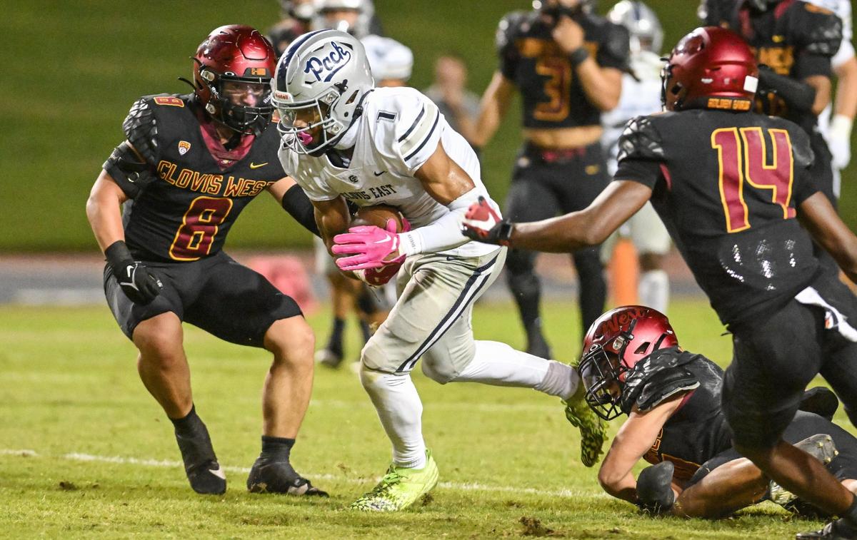 Clovis East’s Tommy Nix finds an opening in the Clovis West defense as he takes the ball up the middle during their game at Veterans Memorial Stadium in Clovis on Friday, Oct. 6, 2023.