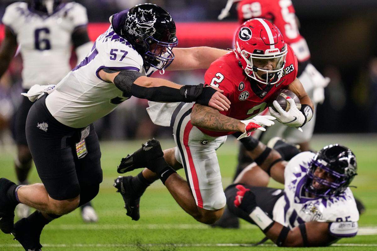 Georgia running back Kendall Milton runs against TCU linebacker Johnny Hodges during the first half of the national championship NCAA College Football Playoff game, Monday, Jan. 9, 2023, in Inglewood, Calif.