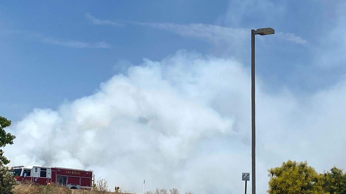 Firefighters and police reportedly evacuated several buildings near a fire on Highway 168 Monday afternoon.