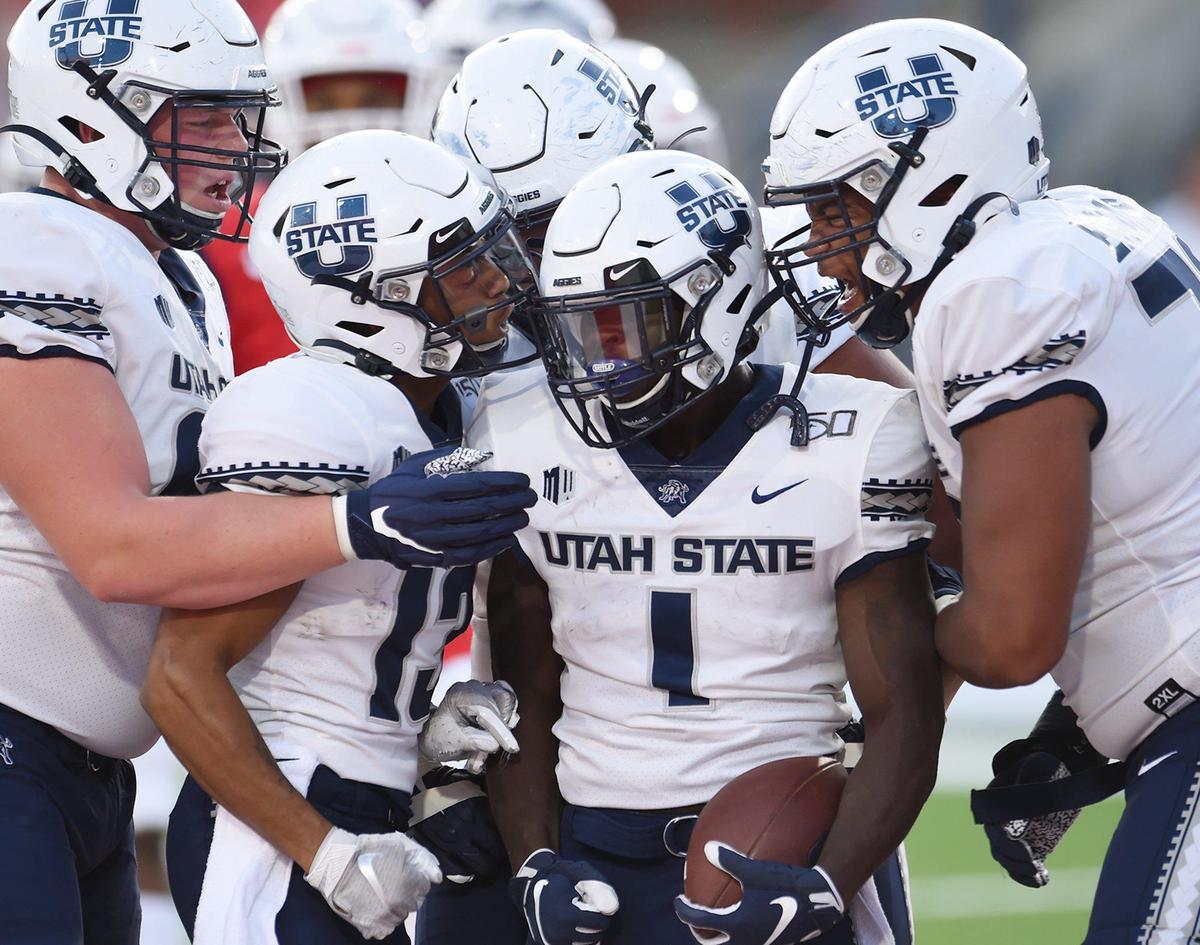 Utah State offense celebrates a touchdown run by running back Gerold Bright against Fresno State, Saturday, Nov 9, 2019 in Fresno. The Aggies rolled up 525 yards of offense in a 37-35 victory.