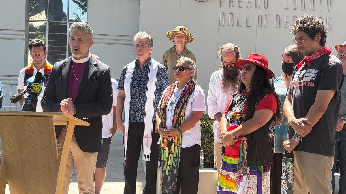 Supporters and members of the Fresno County LGBTQ+ community pray at a gathering Monday, May 11, 2026. Three Fresno County supervisors voted to bar the public library from Pride events, a decision that the author says erases and endangers LGBTQ+ residents.