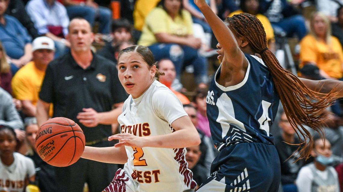 Clovis West’s Ariyah Smith, left, eyes the hoop while driving around Bakersfield’s Radisson Banks during their Central Section Open Division championship game at Clovis West on Saturday, Feb. 26, 2022.
