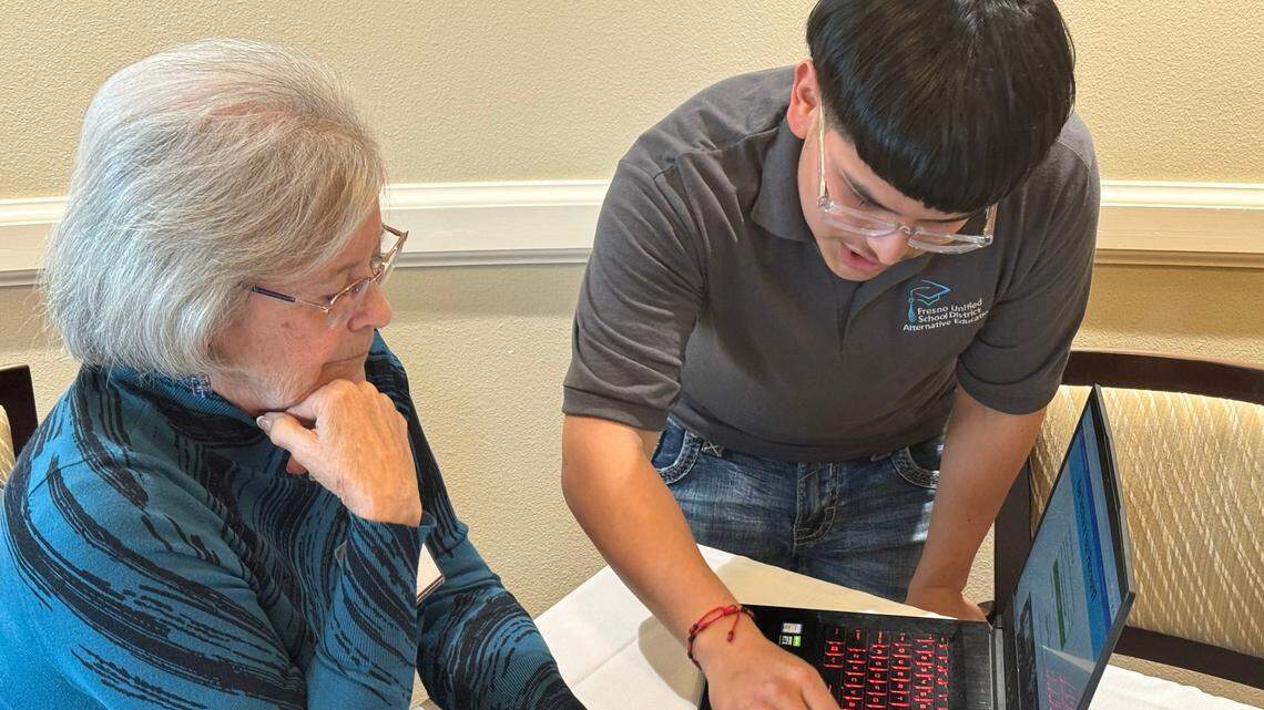 Mary Leas Stegall gets computer instruction from Isai Paredes Guerra in the Seniors Helping Seniors program event, held at the California Armenian Home in Fresno.