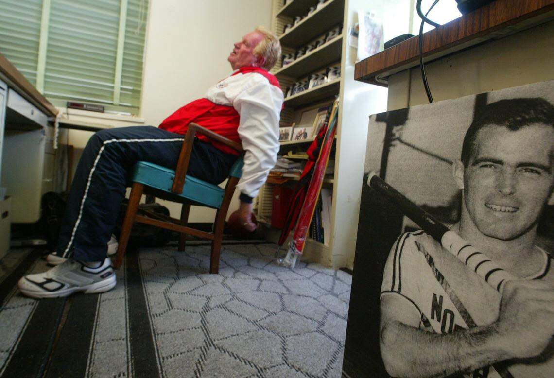 In this file photo from April 2003, track and field coach Bob Fraley leans back in his office and contemplates his work at Fresno State. He later decided to sacrifice his coaching salary to help save the program from being cut from the athletic department budget. At right is a black and white poster of Hall of Famer John Pennel, who became the first 17-foot pole vaulter in 1964.
