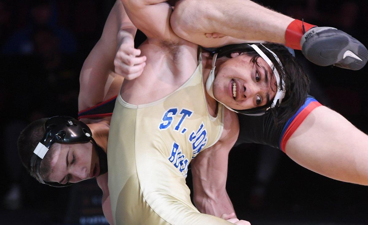 Buchanan’s Sloan Swan, background, is seen against St. John Bosco’s Nicco Ruiz, foreground, in the 152 lb weight bout at the CIF state wrestling championships held Sarurday, Feb. 26, 2022 in Bakerfield.