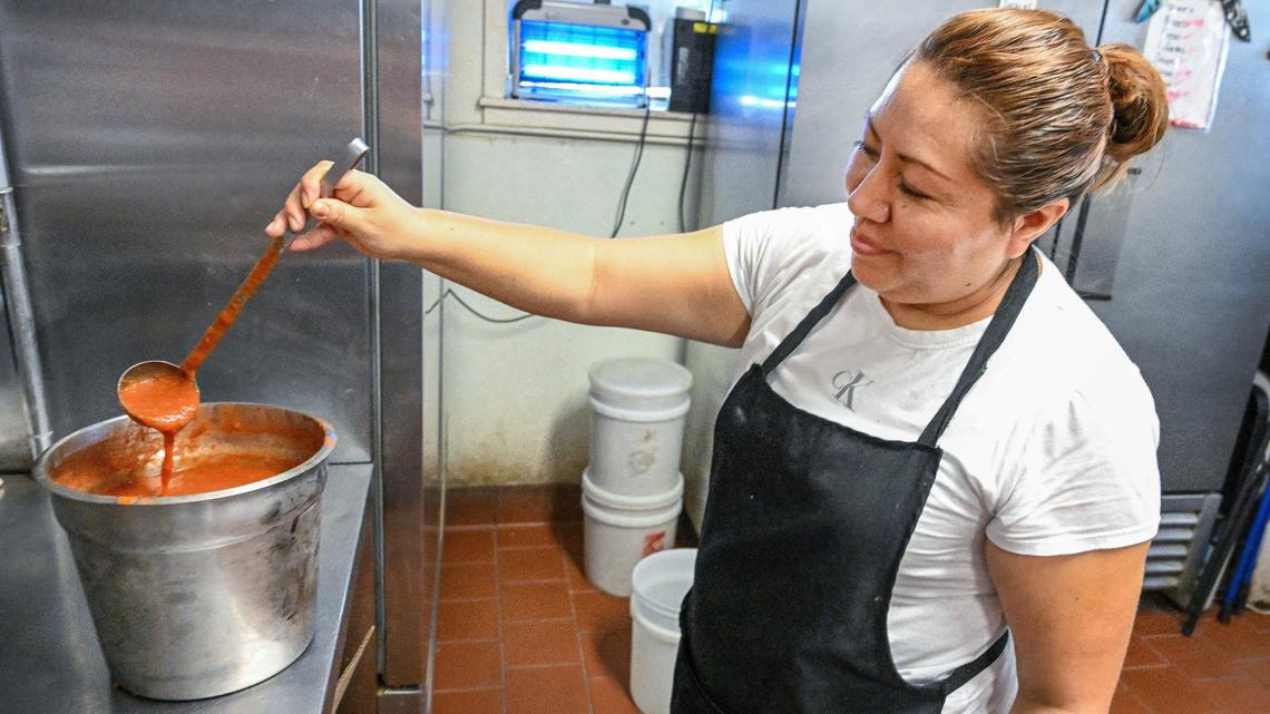 Yolanda Diaz shows off her restaurant’s famous red salsa while working with other members of her family at Adrian’s, a longtime Fresno Mexican food stop, on Monday, June 24, 2024.