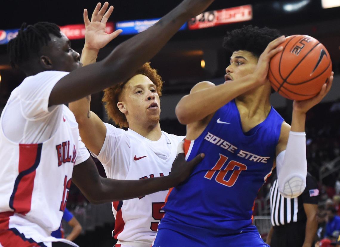 Fresno State’s Aguir Agau, left, and Fresno State’s Noah Blackwell, center, block Boise State’s RayJ Dennis, right, Saturday, Jan. 25, 2020 in Fresno.