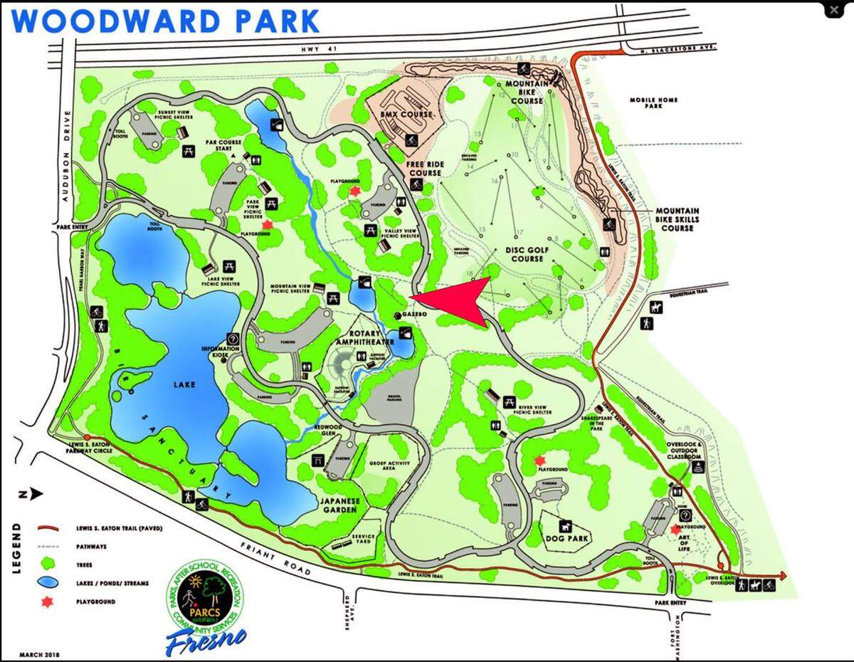 Red arrow marks the now-closed informal parking area at Fresno’s Woodward Park.