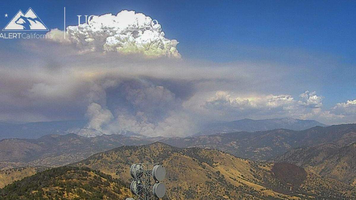 A fire cloud formed above parts of remote areas of Fresno County as the Garnet Fire continued to spread in the Sierra National Forest. The wildfire had burned 12,378 acres and counting with no containment as of 8 p.m. Wednesday. Fresno County has proclaimed a state of emergency.