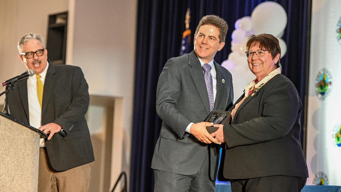 Fresno County Sheriff Margaret Mims accepts the Fresno County Lifetime of Service Award from Supervisor Brian Pacheco, while Scott Miller, President & CEO of the Fresno Chamber of Commerce, speaks during the annual State of the County luncheon at the Fresno Convention Center’s Valdez Hall on Tuesday, September 27, 2022.