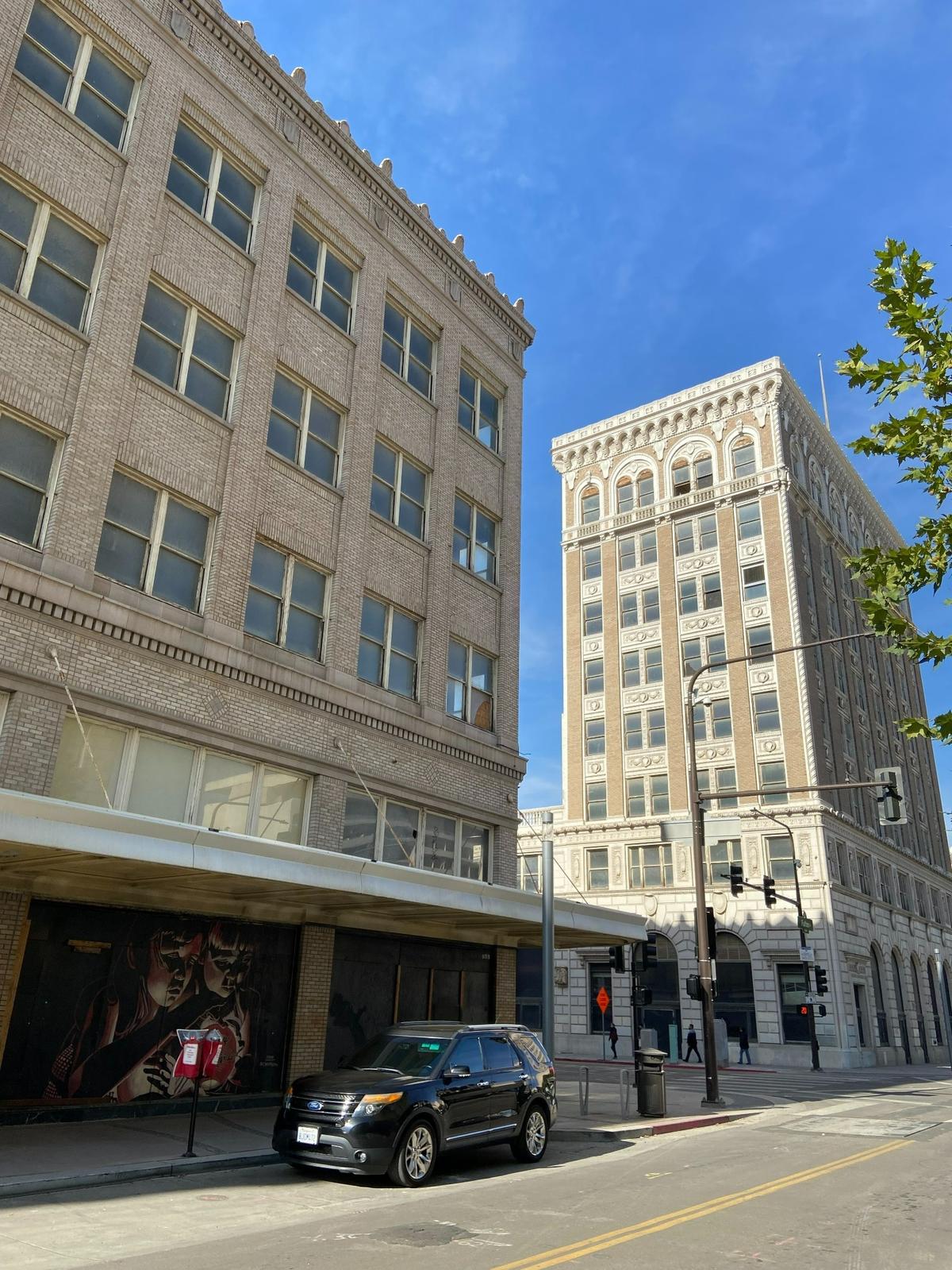 The JC Penney building, left, which opened in 1924 as the Radin-Kamp Department Store, as seen from Fulton Street in downtown Fresno on Oct. 31, 2023. At right is the Bank of Italy building. Both have been vacant for decades.