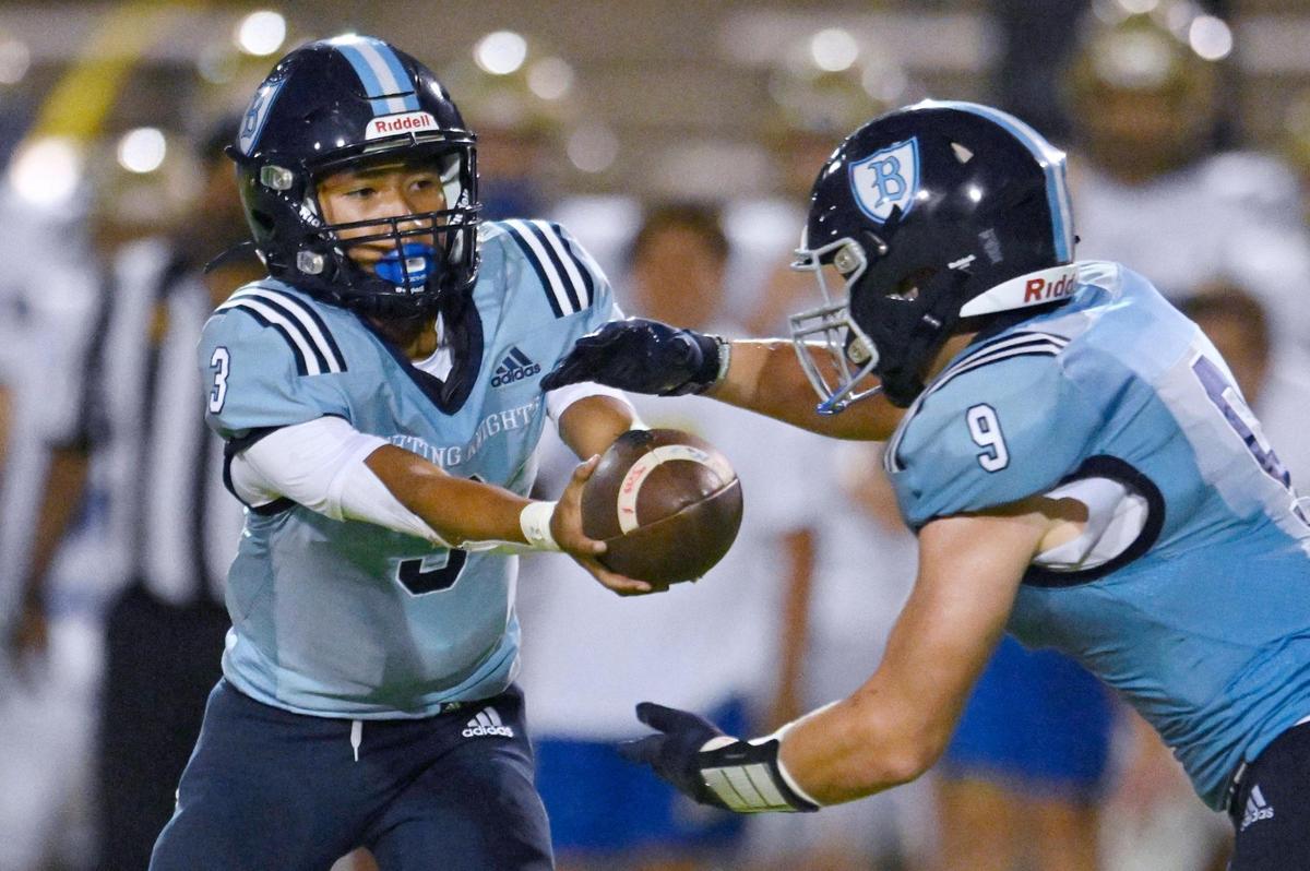 Bullard quarterback Jerren Mao, let, hands off to Nick Stubblefield, right, Friday, Sept. 15, 2023 in Fresno.