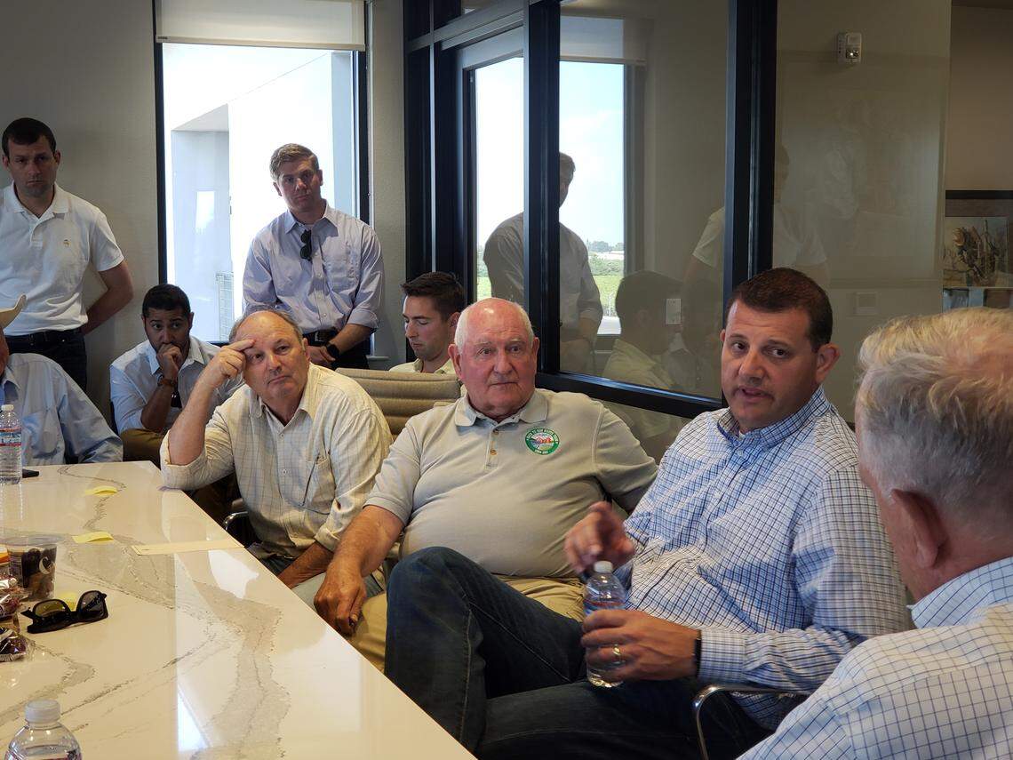 U.S. Ag Secretary Sonny Perdue, center, holds a round table discussion at HMC Farms in Kingsburg, CA on Tuesday, Aug. 14, 2018. Rep. David Valadao, right, accompanied Perdue on his visit.
