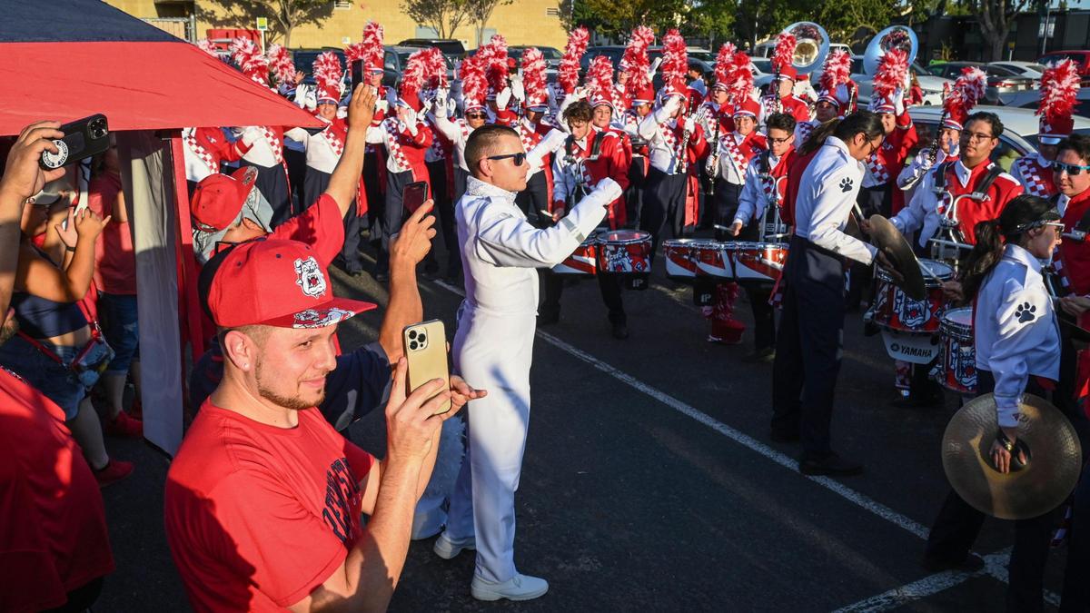 Tailgaters watch the Fresno State Bulldog Marching Band perform before the start of the Fresno State-Cal Poly game at Valley Children’s Stadium on Thursday, Sept. 1, 2022.