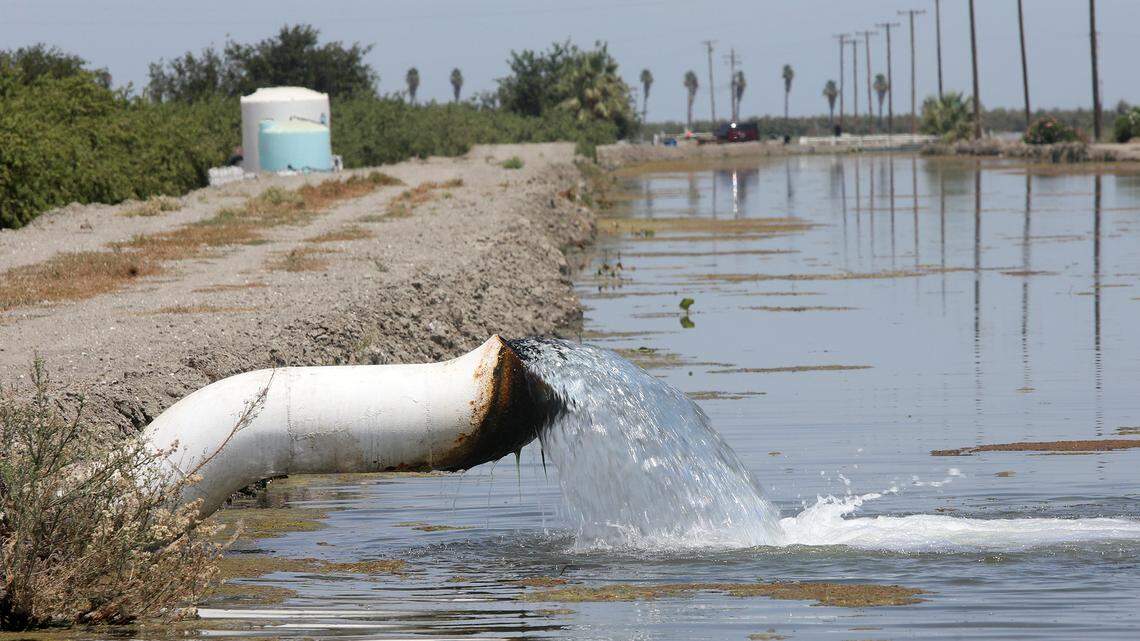 Water gets pumped into a canal near Tranquillity. Overpumping of ground water for agriculture has led to land subsidence.