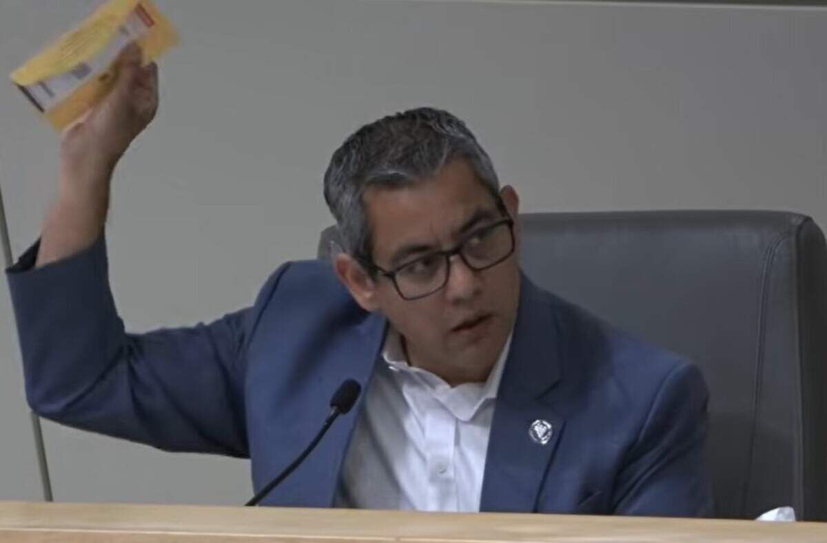 Fresno City Councilmember Miguel Arias holds up a parking ticket during the June 25, 2026, Fresno City Council meeting.