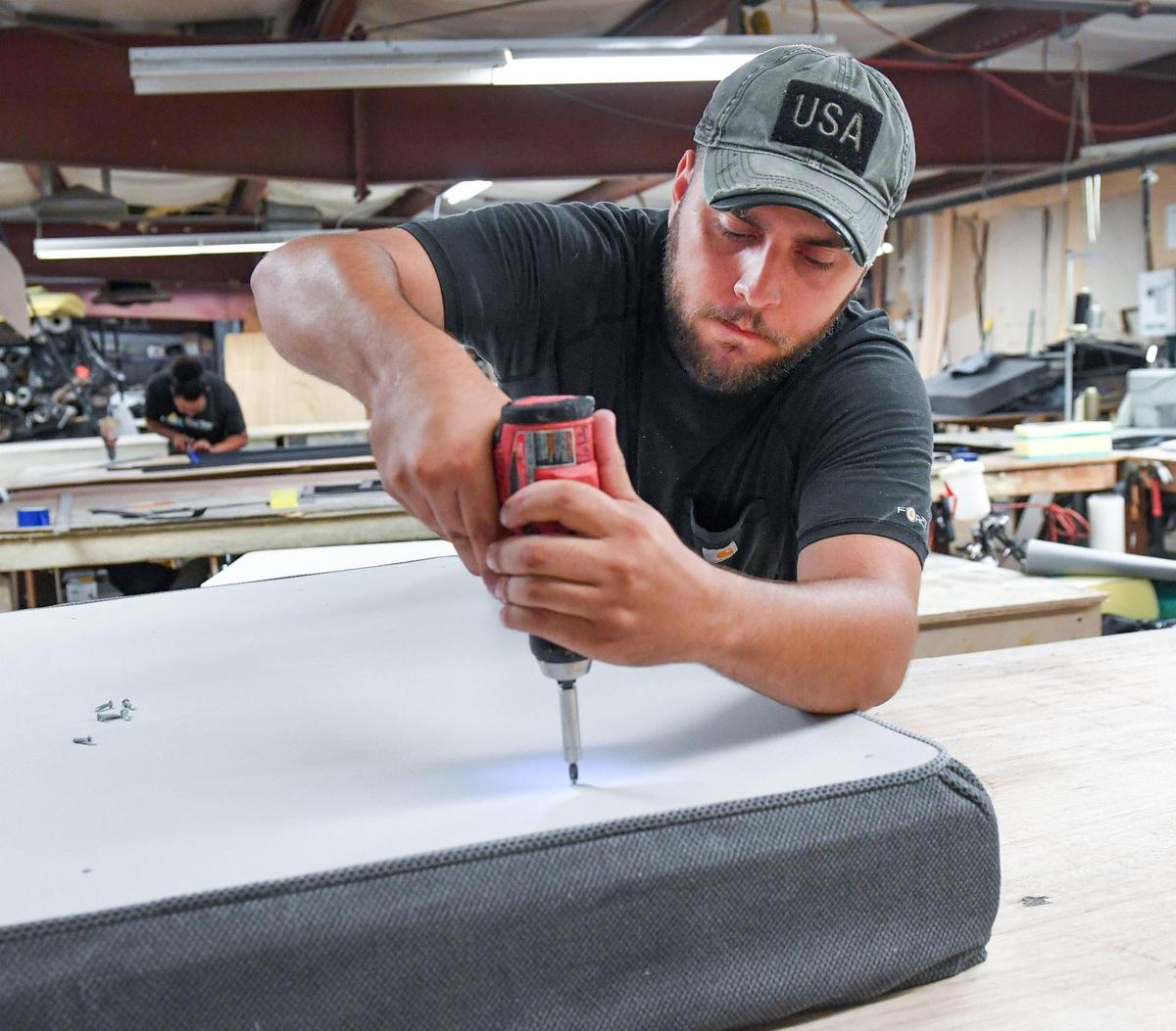 Isaiah Rivera works on mattress cushions to be used in custom camper vans at Field Van on Wednesday, Aug 11, 2021.