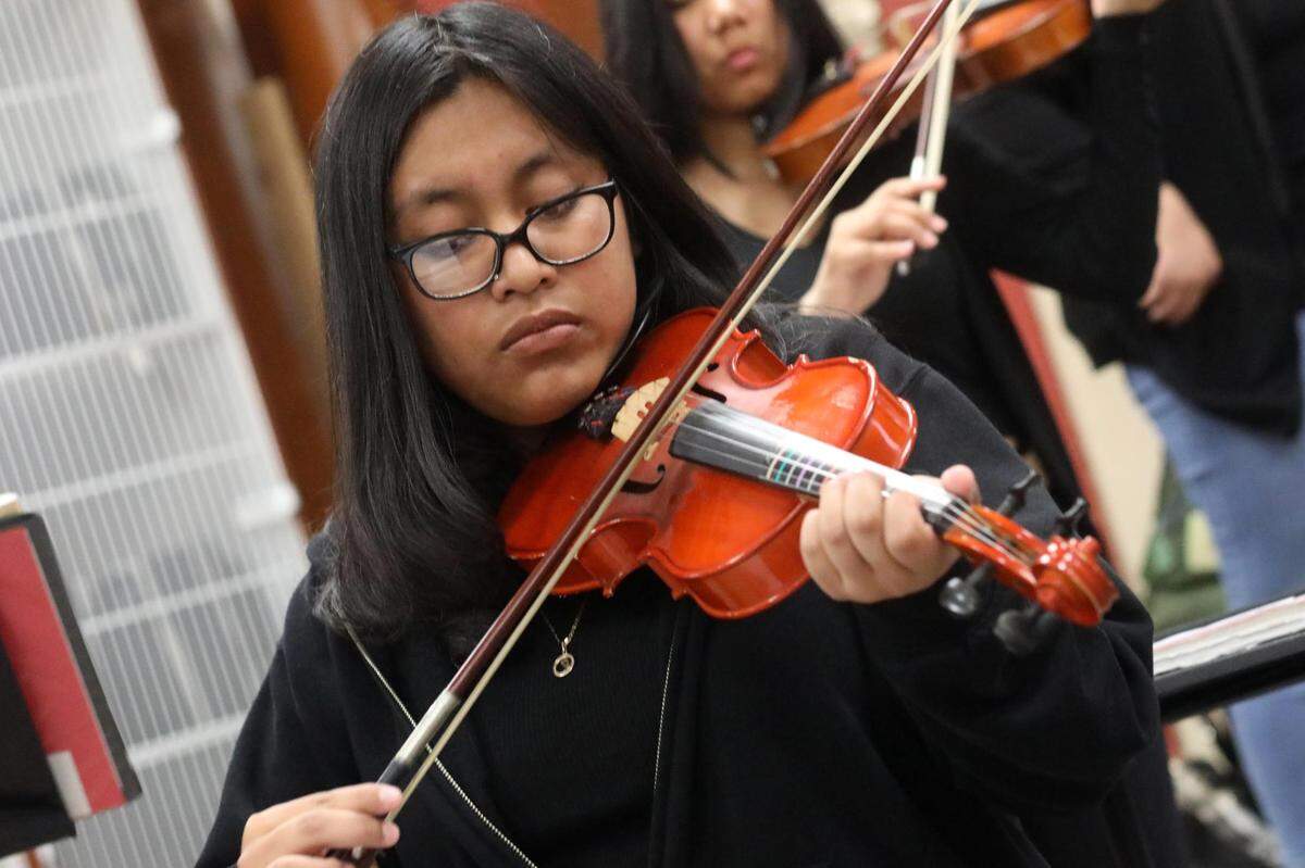 Orosi High School Mariachi Cardenal violin player during the mariachi class on Wednesday, March 15, 2023.