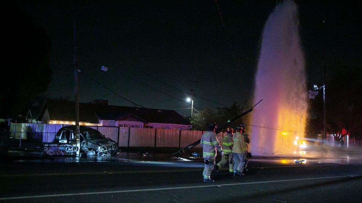 A car crash at the Olive and Recreation Avenues intersection caused a fire hydrant to shoot water into the air on Sunday, Nov. 28, 2021.