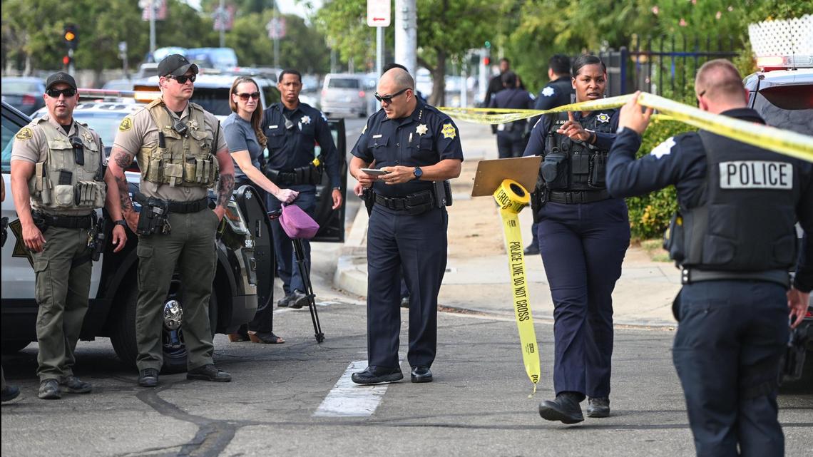 Fresno Police Chief Paco Balderrama, center, collects information on a homicide that occurred in the roadway on Union Avenue at Cedar near McLane High School on Monday, Sept. 18, 2023.