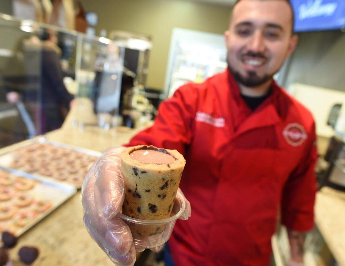 Gabriel Acevedo, owner, Acevedo’s Postreria Gourmet in North Fresno, holds a chocolate chip cup drink.