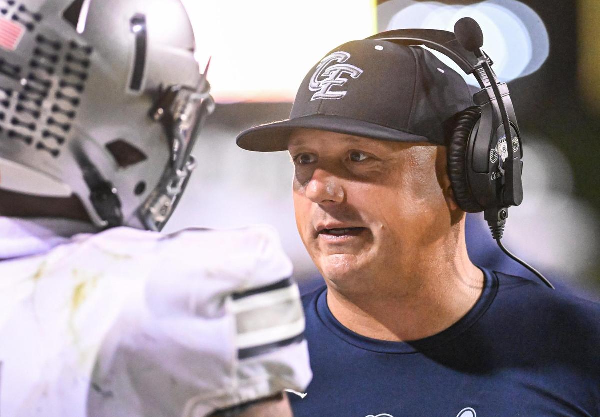 Clovis East head football coach Brandon Nagle checks in with player Tommy Nix on the sideline during their game against Clovis West at Veterans Memorial Stadium in Clovis on Friday, Oct. 6, 2023.