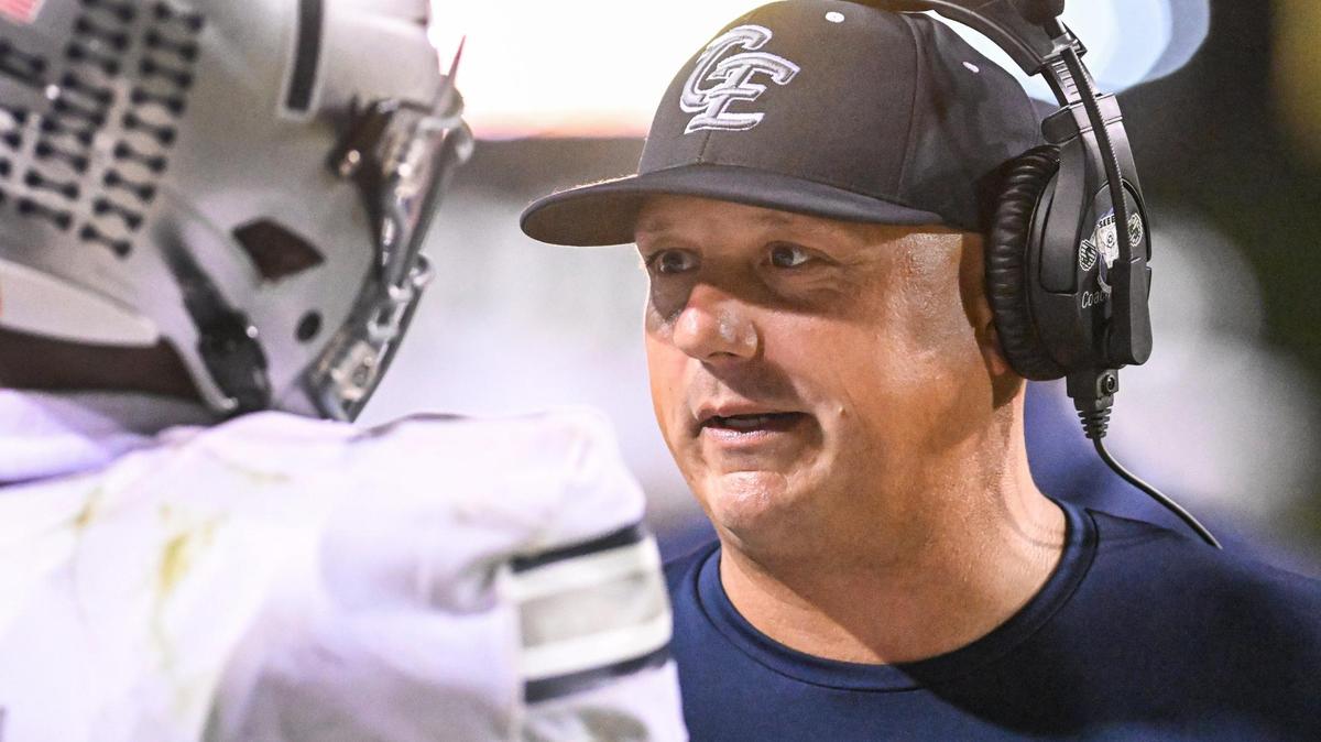 Clovis East head football coach Brandon Nagle checks in with player Tommy Nix on the sideline during their game against Clovis West at Veterans Memorial Stadium in Clovis on Friday, Oct. 6, 2023.