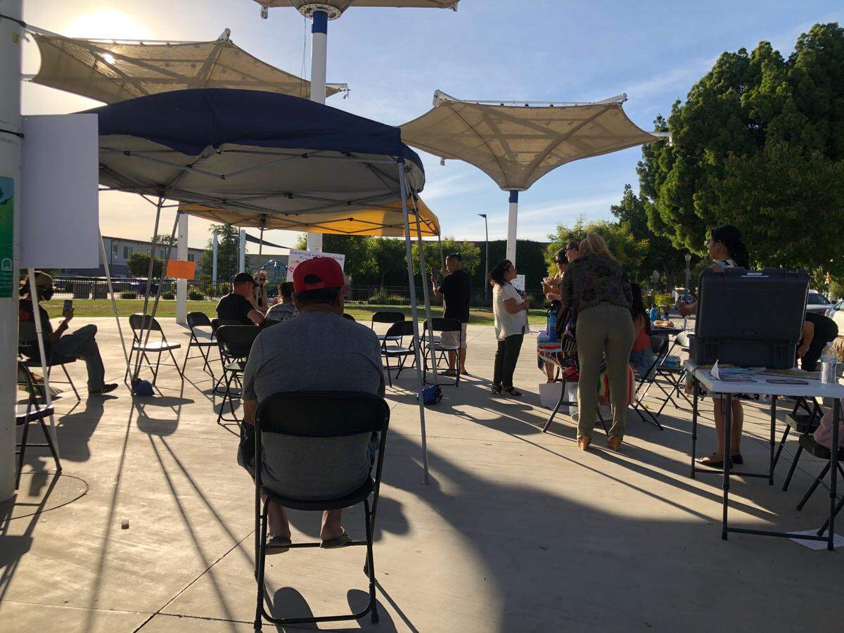 Attendees gather at the State of the People of the City event at downtown Fresno’s Cultural Arts Park on May 19, 2022.