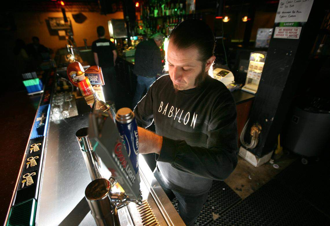 James Stapleton, a bartender at Babylon Club in the Tower District, pours a beer at the club in this file photo from 2010 when the pool hall was in full swing. It’s been closed since 2013.